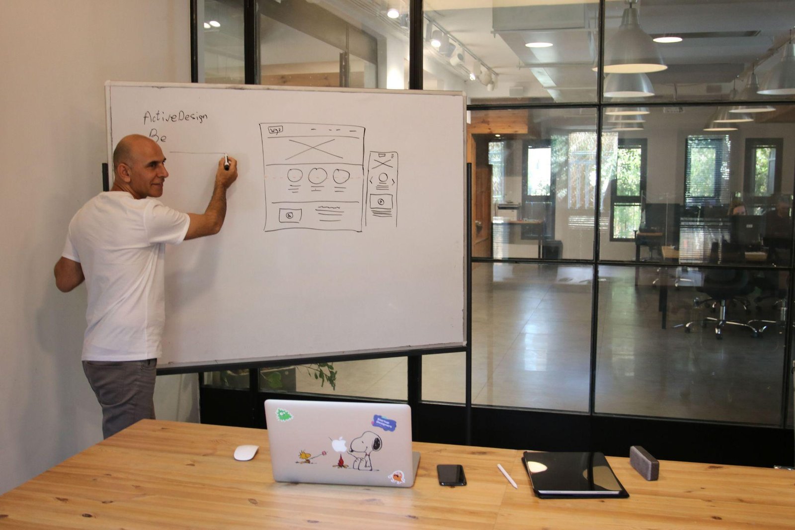 Designer sketching on a whiteboard